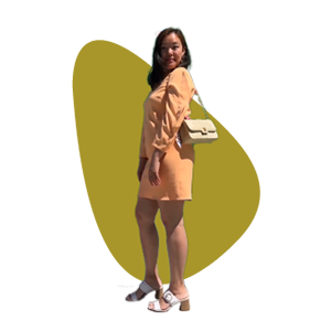 An image of a person wearing a pink dress and white purse